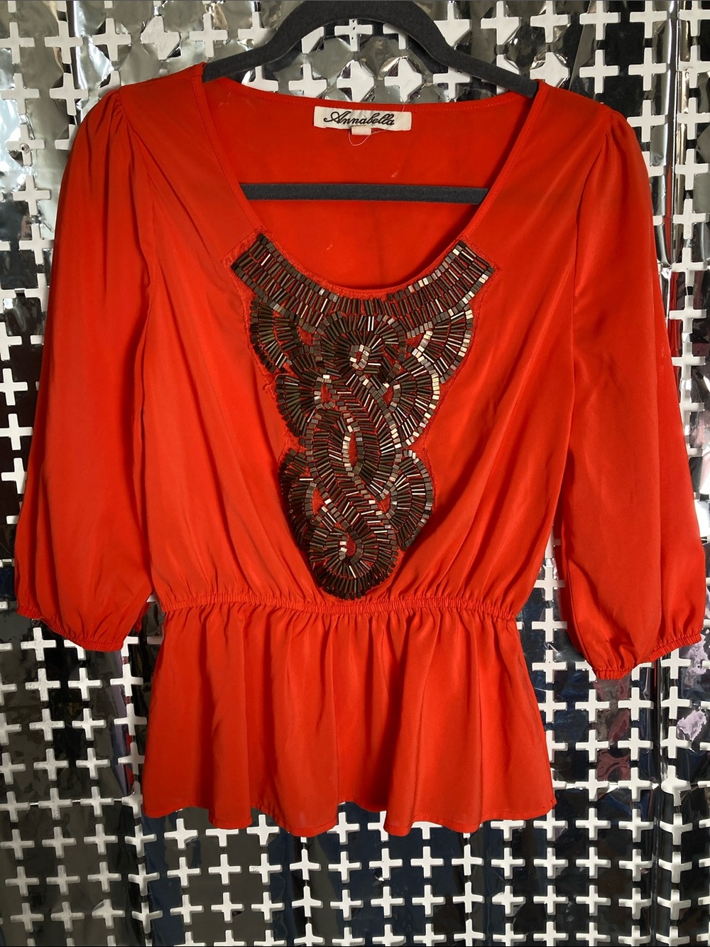 Annabelle Red-Orange Peplum Top with Black Beaded Bib